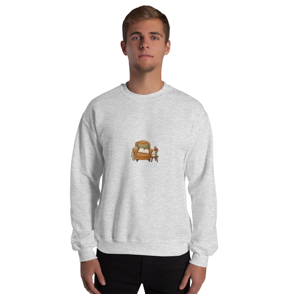 Model wearing Cozy Reading Chair unisex sweatshirt in Ash, front view with armchair, open book and side table