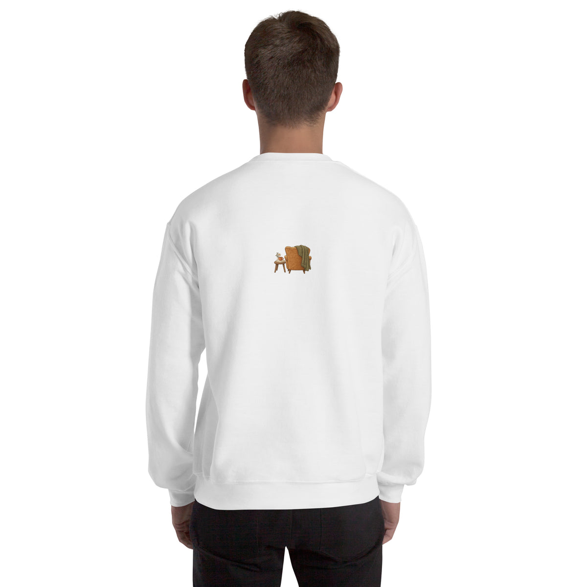 Model wearing Cozy Reading Chair unisex sweatshirt in White, back view with small armchair illustration
