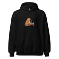 Black pullover hoodie with a tea-drinking animal beside a small table illustration
