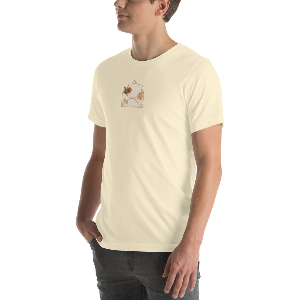 Model wearing Floral Letter unisex T-shirt in Natural, angled front view with botanical envelope print