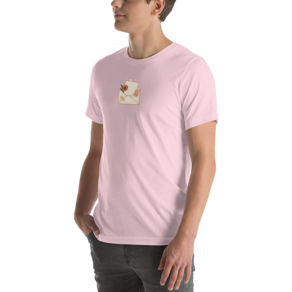 Model wearing Floral Letter unisex T-shirt in Soft Pink, angled front view with botanical envelope print
